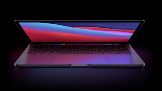 Apple MacBook vor dunklem Hintergrund