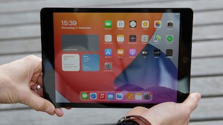 Hände halten das iPad 10.2 in die Kamera.
