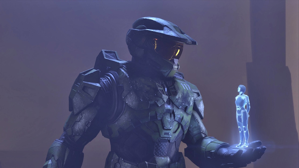 An armored soldier speaks with a small blue hologram.