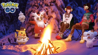 Ein junger Mann und eine junge Frau sitzen mit einigen Pokémon an einem Lagerfeuer im Schnee.