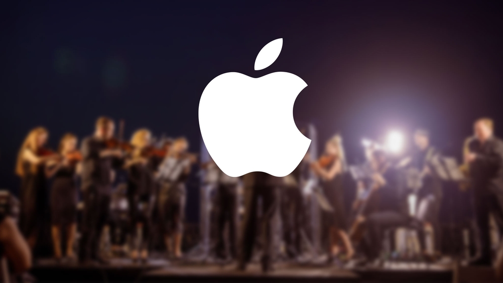 Apple-Logo vor einem Kammerorchester