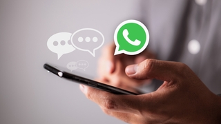 Handy mit Text-Blasen und WhatsApp-Logo