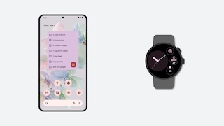 Ein Smartphone und eine Uhr vor grauem Hintergrund.