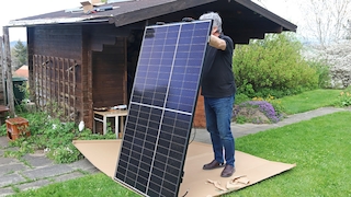 Mann hält Solarmodule