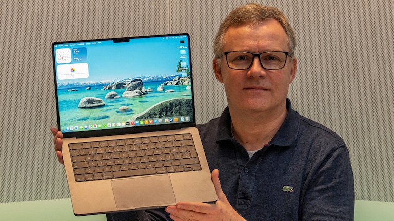 Testredakteur Sven Schulz hält das Apple MacBook Pro 14 Zoll in die Kamera.