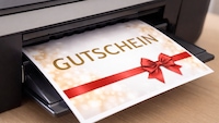 Gutschein kommt aus einem Drucker