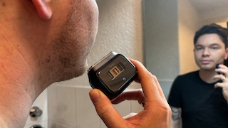 Eine Person rasiert sich mit dem Laifen P3 Pro vor dem Badezimmerspiegel. Durch das transparente Sichtfenster des Rasierers sind der Linearmotor und die Kupferspule sichtbar.