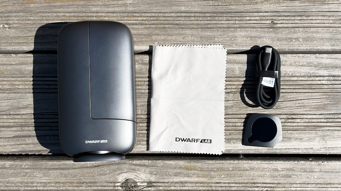 Dwarf Mini mit Putztuch, USB-C-Kabel und ND-Filter auf einer Holzbank.